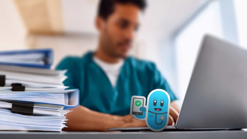 A Clinician Working Through Case Files on his Laptop Computer