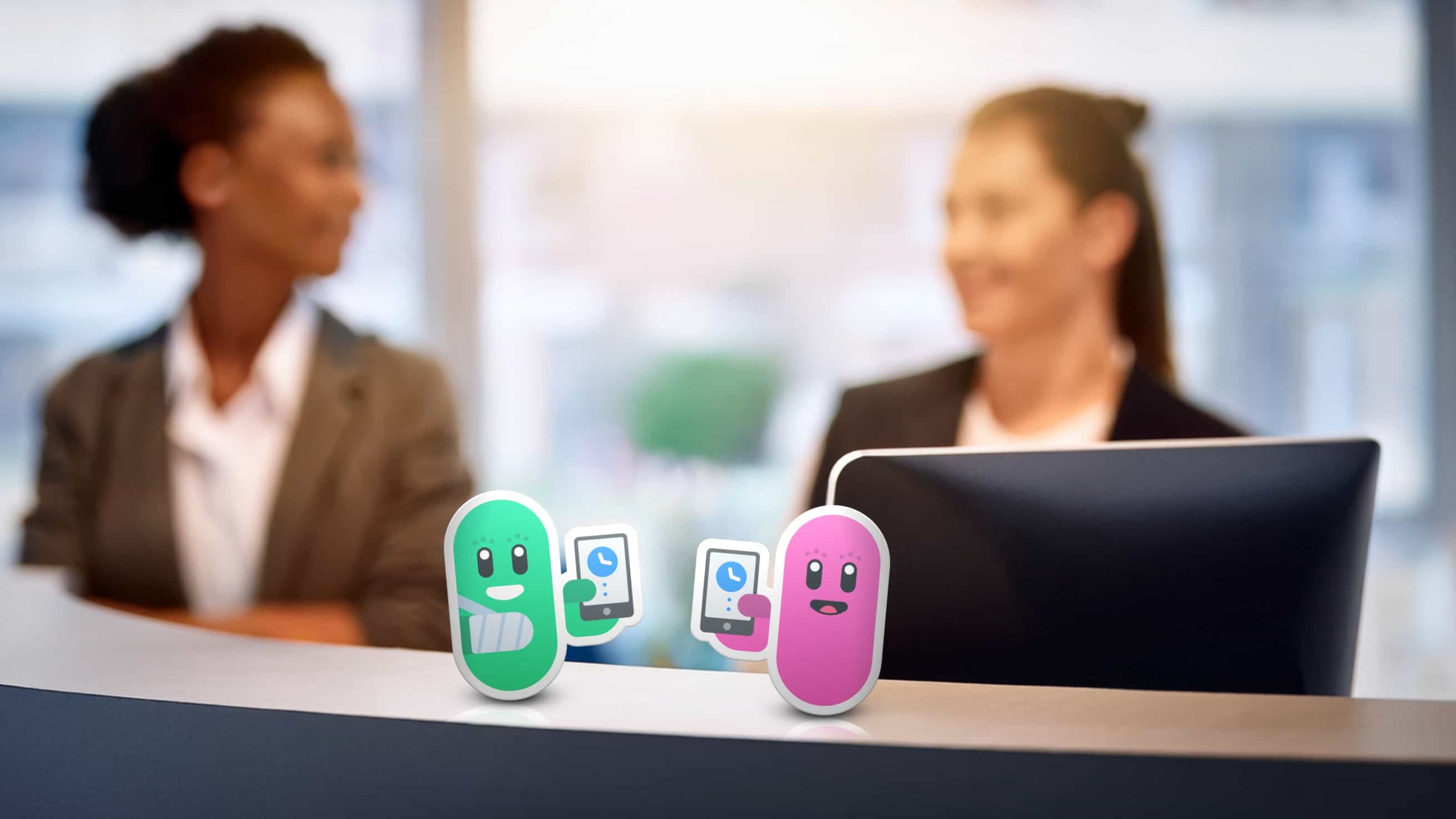 Two Allied Health Clinic Receptionists sitting behind a Desk